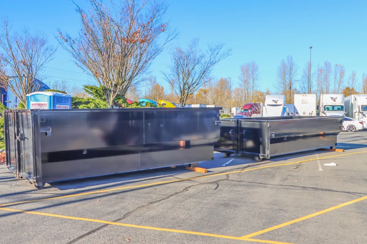 Professional dumpster rental service with roll-off container on residential driveway in Gaines